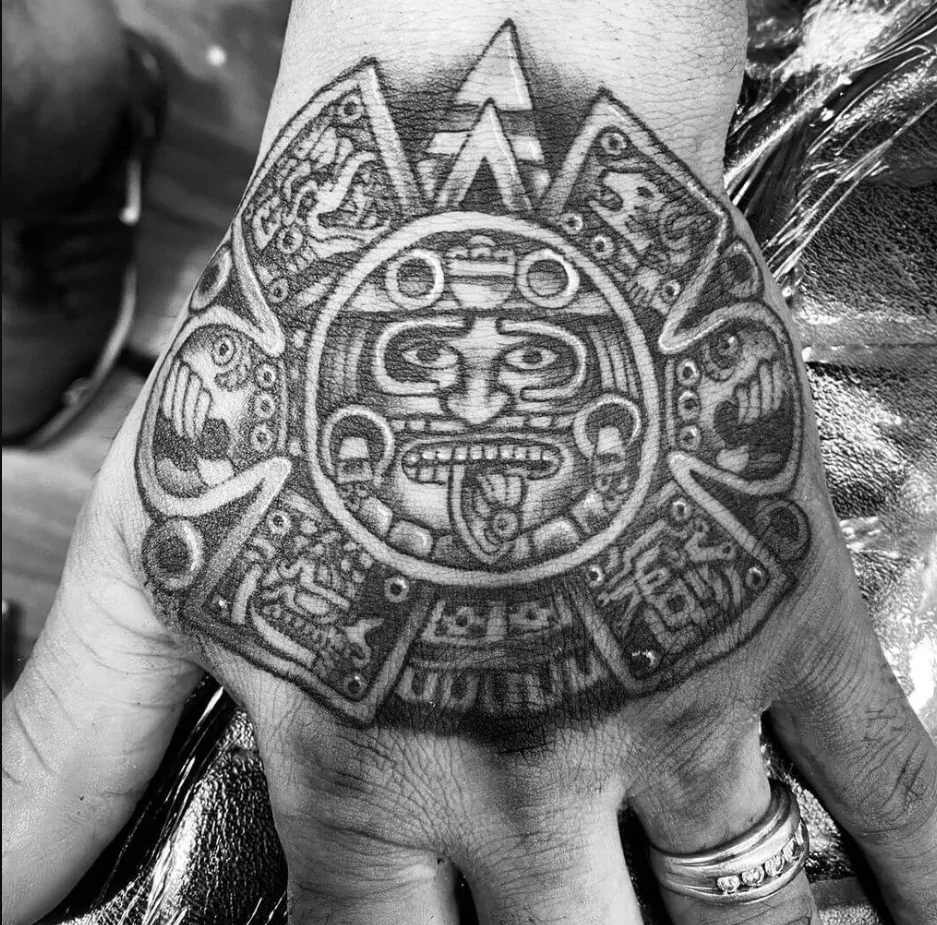 Aztec calendar tattoo design with detailed sun stone patterns